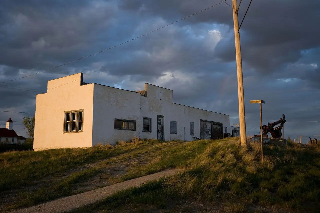 Old white building on the prairie at sunset, 2009