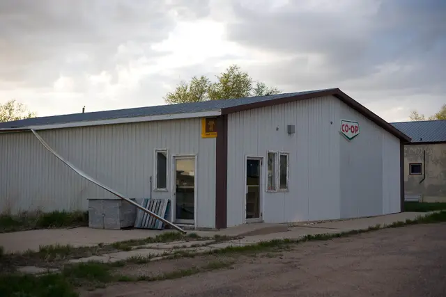 Old Co-op building with liquor vendor sign